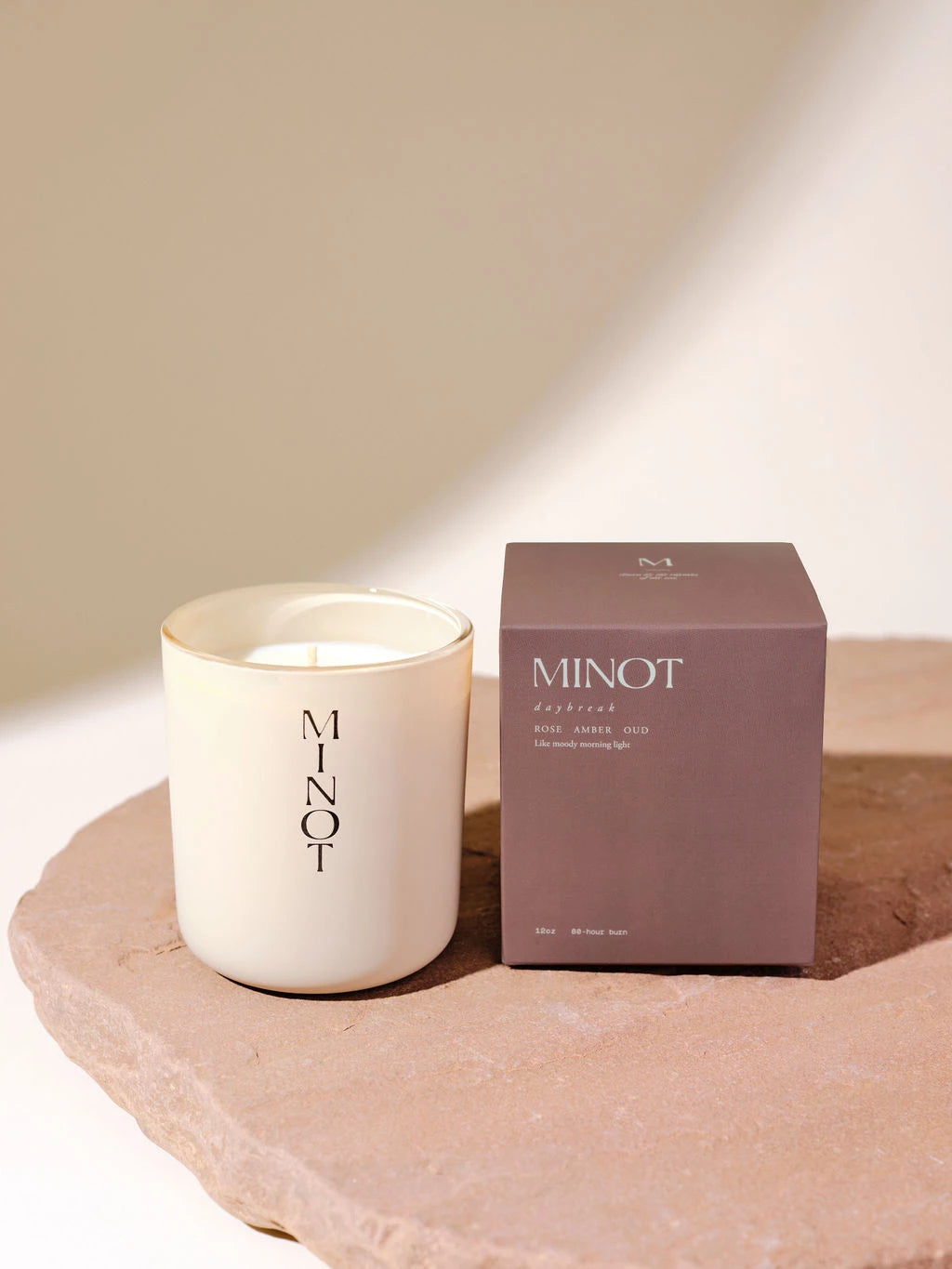 The vegan Daybreak soy wax candle features a bright, smoky scent blend of rose, amber, and oud