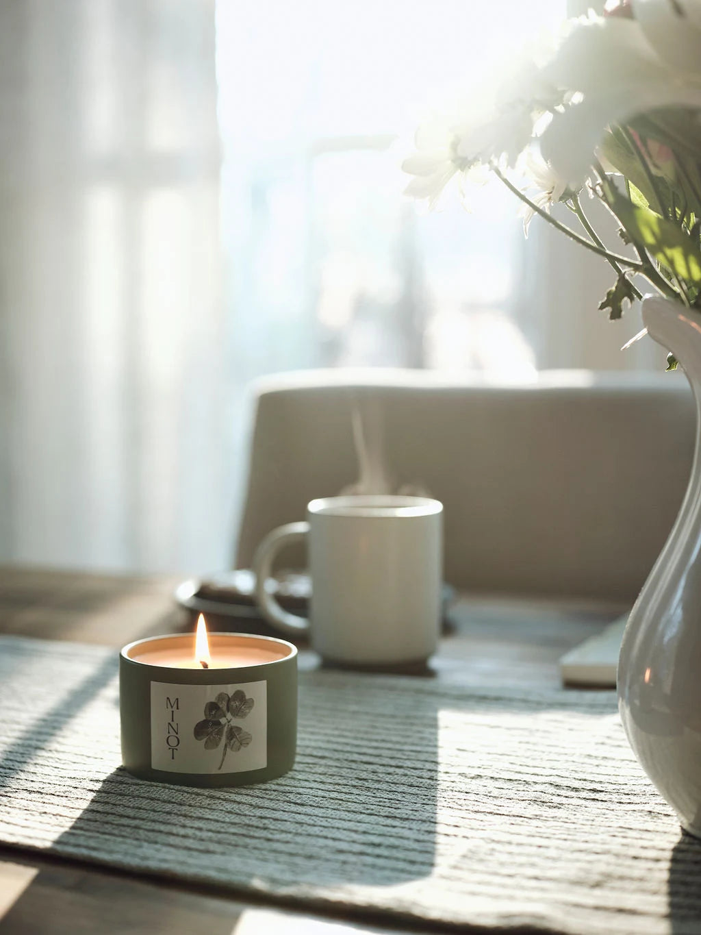 The Lucky Charm candle has citrus, soft floral and cedar scents and a four-leaf clover watercolor