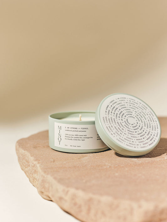 Strong + Fierce affirmation candle is a sandalwood, patchouli, and jasmine blend in a travel tin