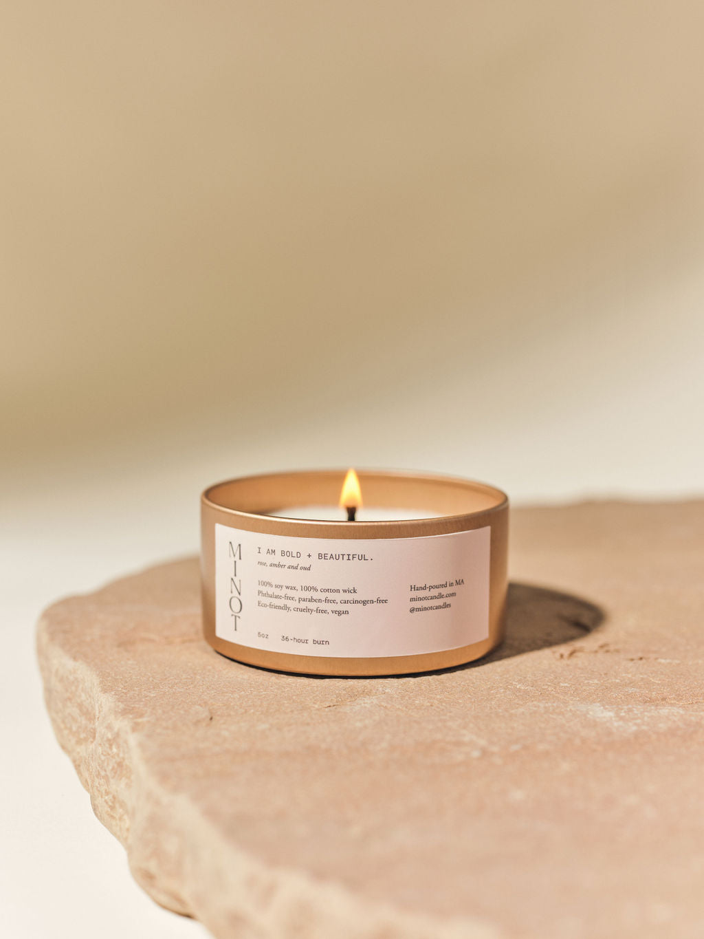 Our Bold + Beautiful affirmation candle features a blend of rose, amber, and oud in a travel tin