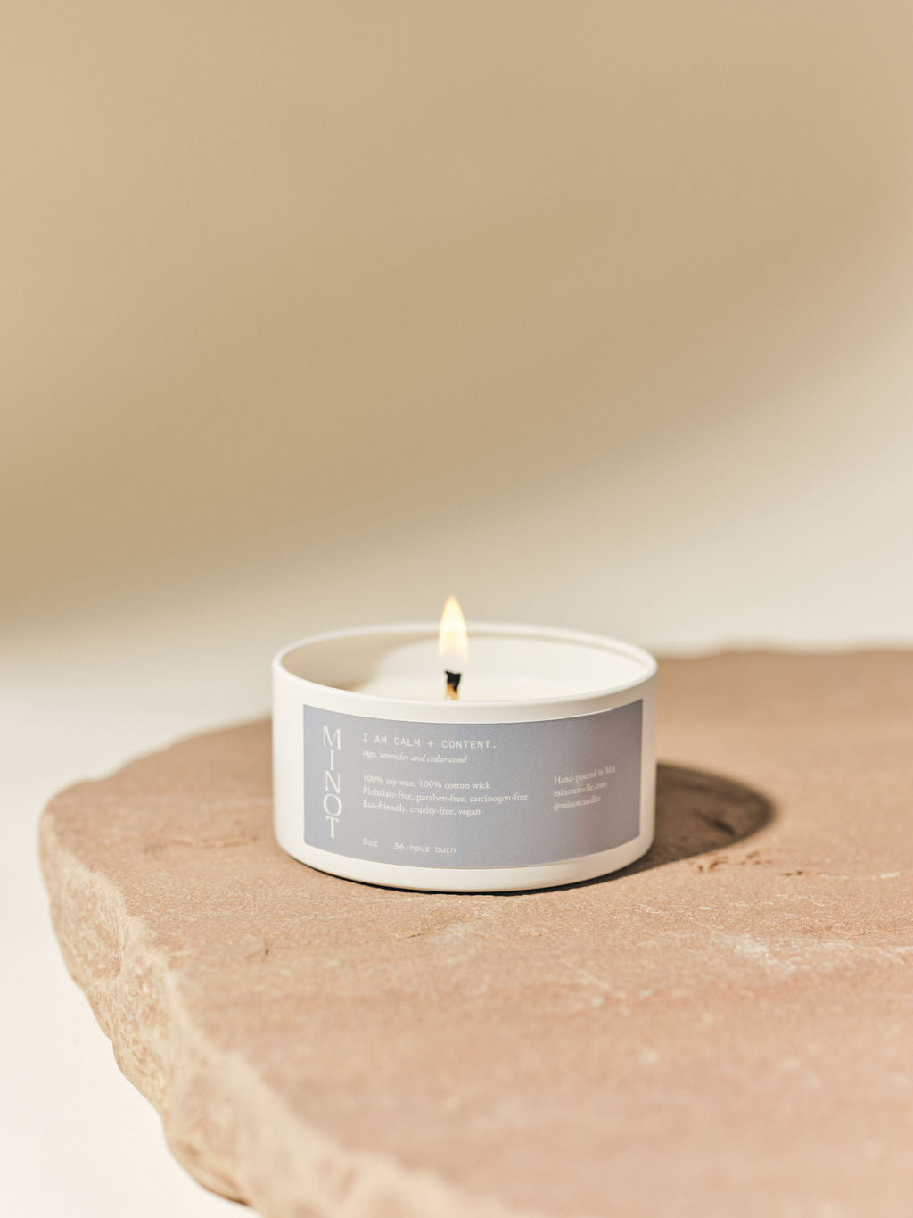 The I Am Calm + Content affirmation candle in tin features calming lavender, sage and cedar scents