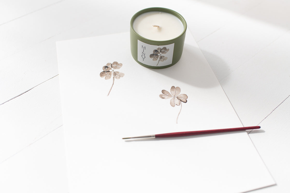 The hand-poured Lucky Charm candle is made with soy wax, cotton wick and plant-derived fragrances