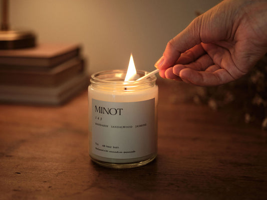 A hand lights the 143 (meaning "love") candle, emitting scents of mandarin, sandalwood and jasmine