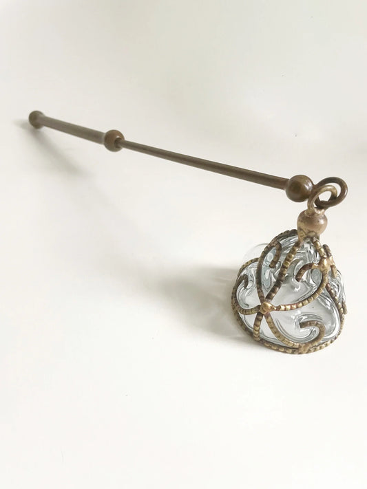 MINOT's antique candle snuffer is 12 inches long with handblown glass bell and ornate brass filigree