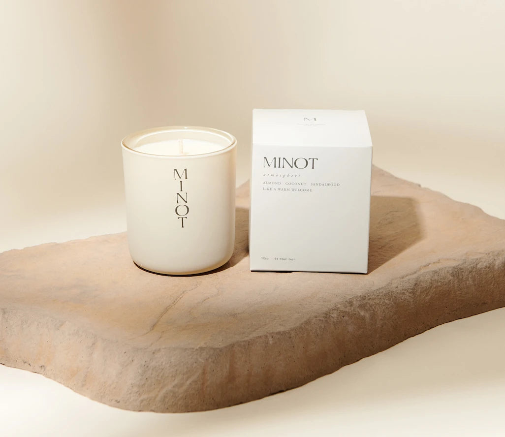 The Atmosphere candle is clean, minimalist luxury with scents of almond, coconut, and sandalwood