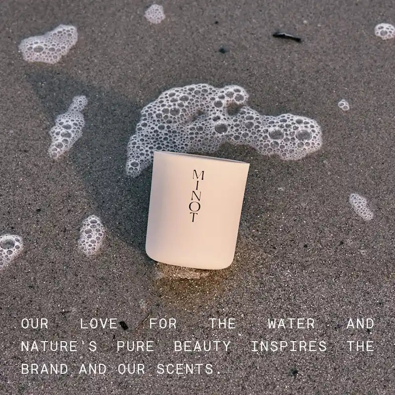 Text on a beach: Our love for the water and nature's pure beauty inspires the brand and our scents