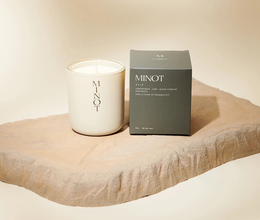 The clean-burning Dusk candle emanates notes of patchouli and lemongrass next to its olive-green box