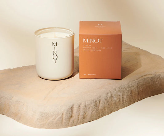 Voyage is a natural, non-toxic coconut candle with cedar, vetiver, and amyris notes in an orange box