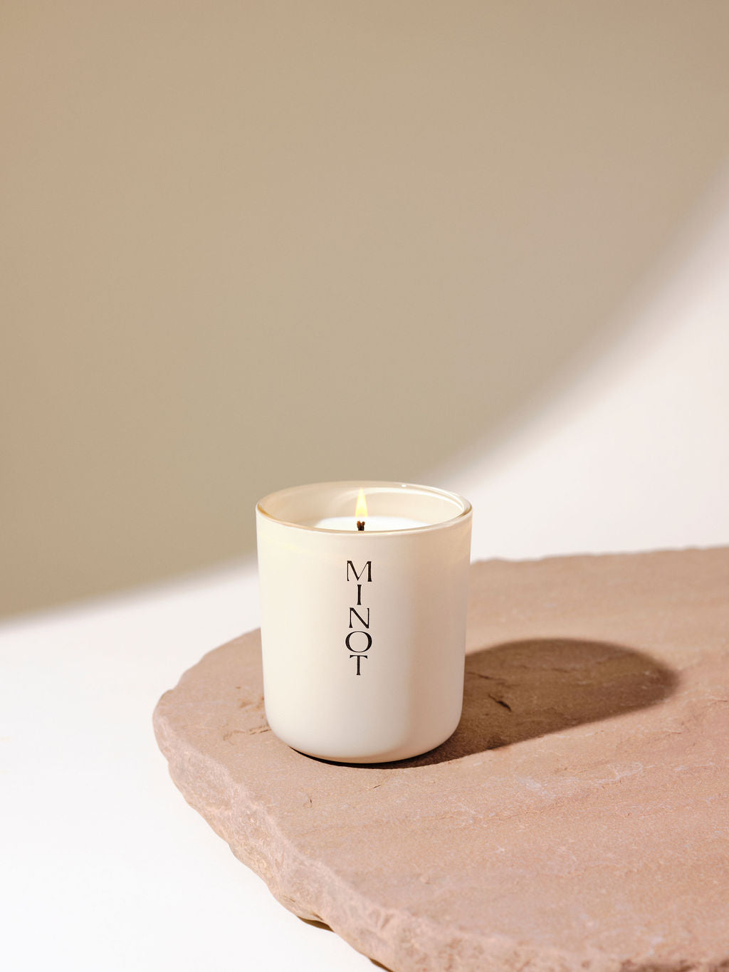 Daybreak is a rose-scented candle with smoky notes of oud and amber in a minimalist glass vessel
